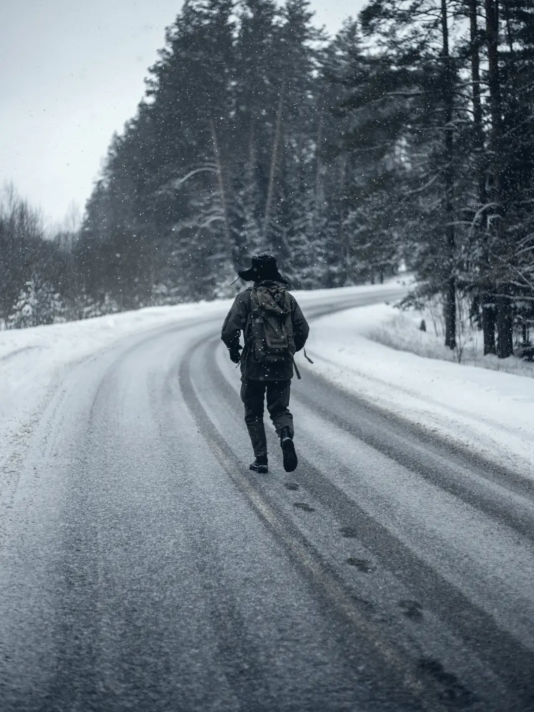 Person rucking down a snowy road