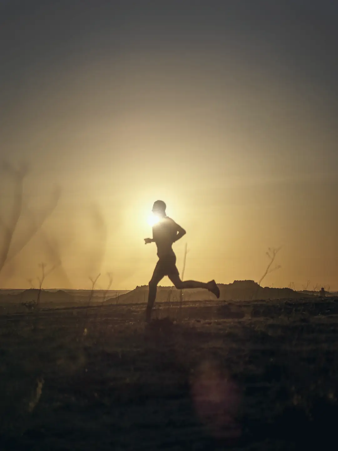 Runner silhouetted at sunset